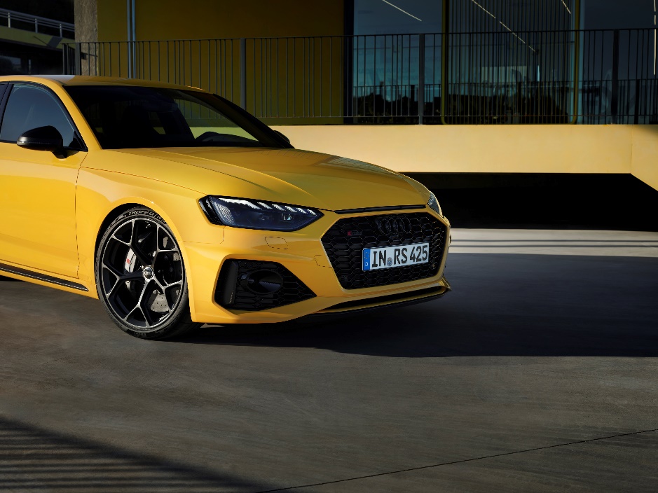 A yellow car parked in front of a building

Description automatically generated